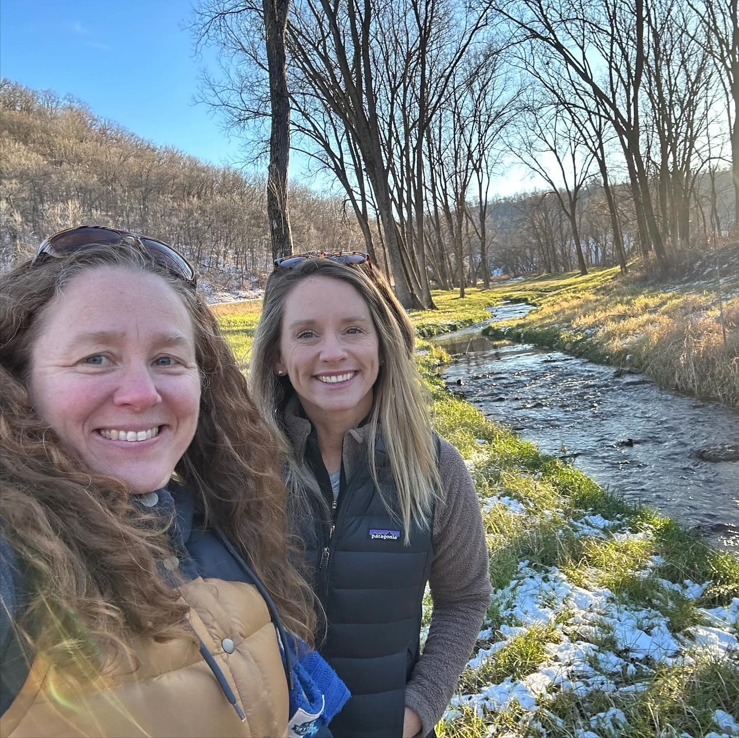 Kristen Poppleton and Jennifer Biederman walking a trout tream